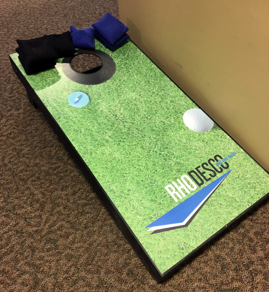 Custom printed logo on corn hole game with black and blue corn sacks